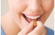 Teenage girl taking vitamin